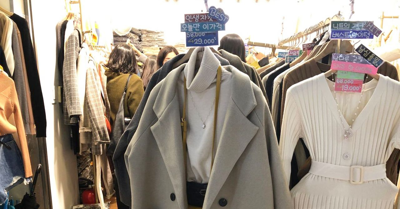 Inside view of a bustling Korean boutique showcasing trendy clothing