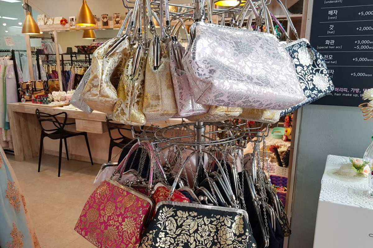 Colorful array of flower crowns for Hanbok styling at InKorea Hanbok shop, Seoul.