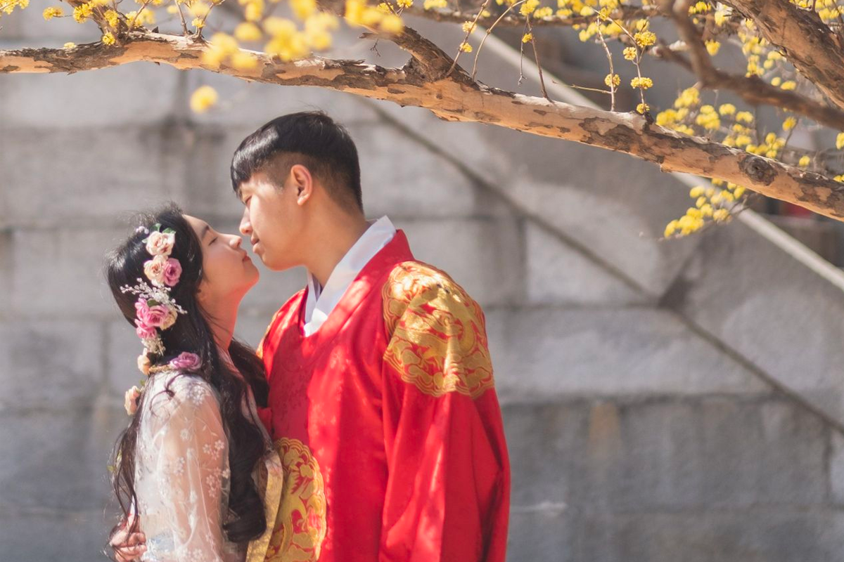 Colorful display of folded Hanbok tops at InKorea Hanbok rental shop.