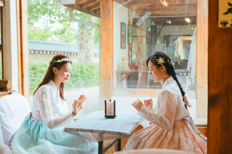 Front view of 'Ohneul Haru Hanbok,' showcasing displayed hanboks and lively street.