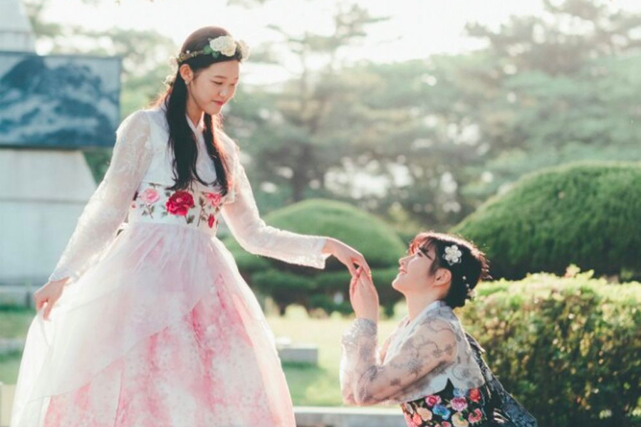 Gyeongbokgung visitors posing in hanbok, capturing the essence of Korean tradition.