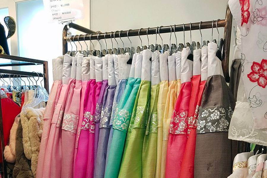 Decorated and vibrant hanbok beautifully displayed inside 'Ohneul Haru Hanbok' shop.