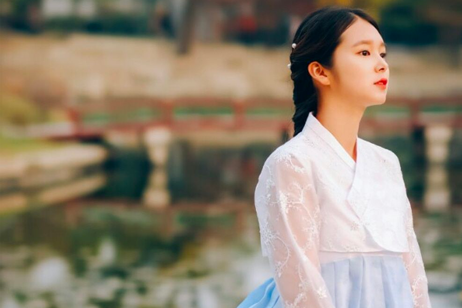 Group of visitors at Gyeongbokgung dressed in theme hanbok, enjoying the sights.