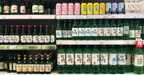 Korean soju and alcohol options on a store shelf.