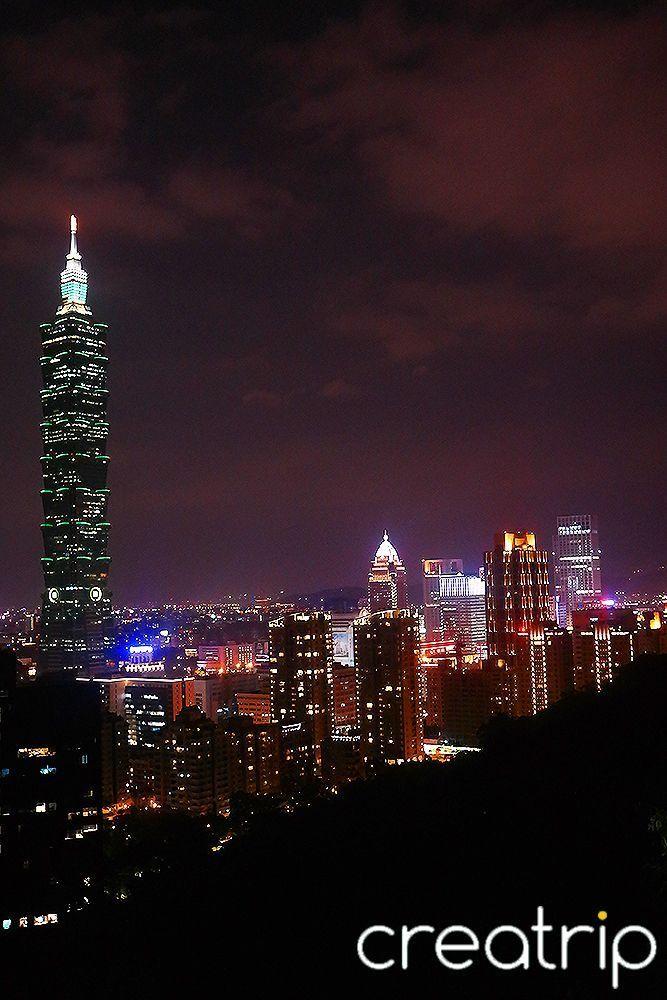 View of Taipei 101 at night, showcasing its position as Taiwan's tallest building and a popular tourist attraction for its dining and shopping options and stunning city skyline views.