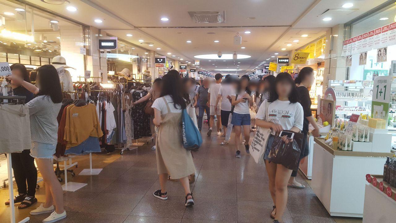 繁忙的地下商街內，購物者川流不息，享受購物的樂趣和折扣優惠。