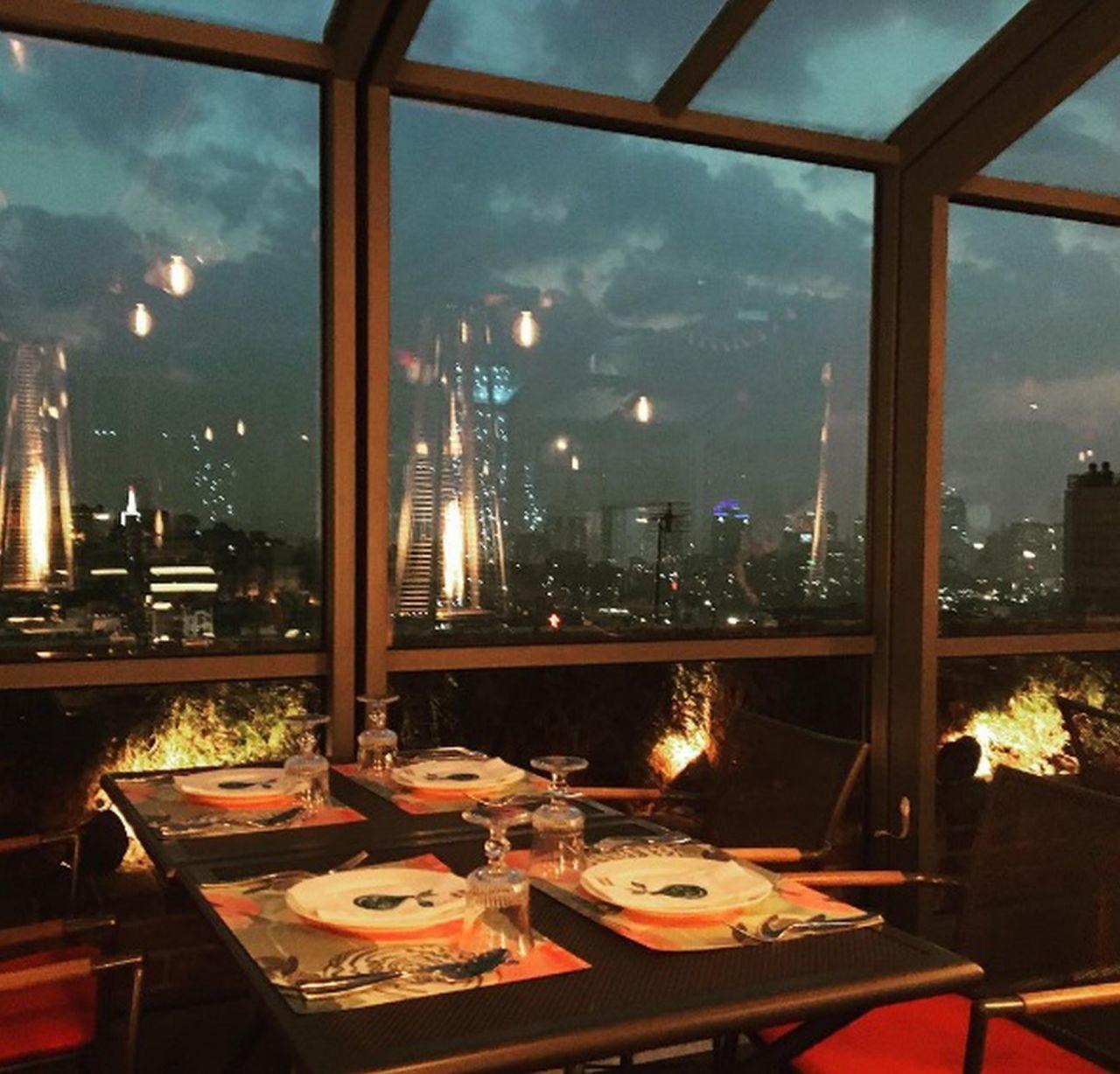 Night view from HARVEST Namsan rooftop restaurant, displaying the Seoul cityscape