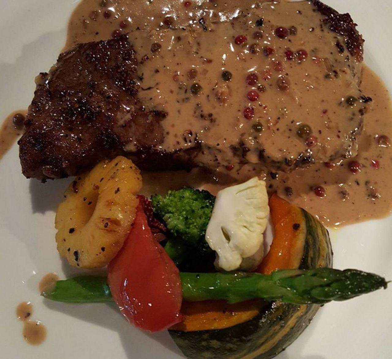 Steak drizzled with pepper sauce and assorted vegetables at HARVEST Namsan in Itaewon