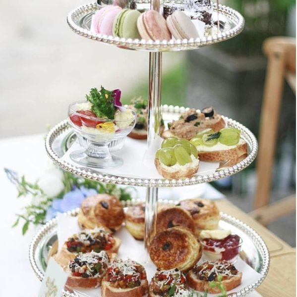 Stylish Korean afternoon tea array featuring a range of sophisticated desserts on a tiered platter, ideal for delightful leisure time in Seoul.