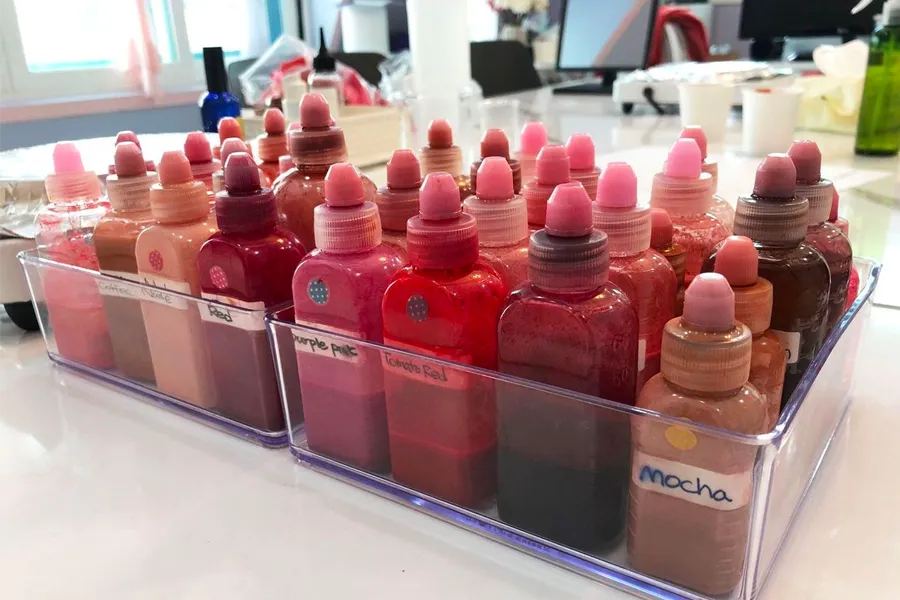 Set of colorful lip tint bottles from Korean cosmetics DIY workshop, offering DIY beauty products with natural ingredients.