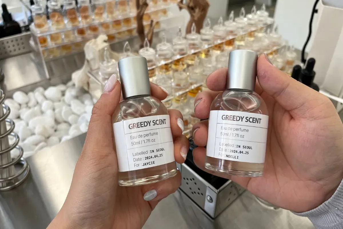 Bottle of handmade perfume crafted at Korean DIY workshop in Seoul, labeled with a personal touch for unique scent creation.