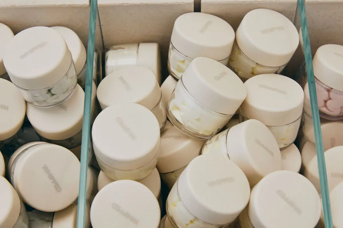 Containers filled with homemade Korean skincare products from Whipped, emphasizing eco-friendly DIY beauty products.