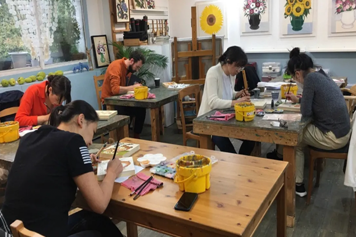 Group of participants engaging in Korean traditional folk painting workshop, focusing on cultural art and creativity.