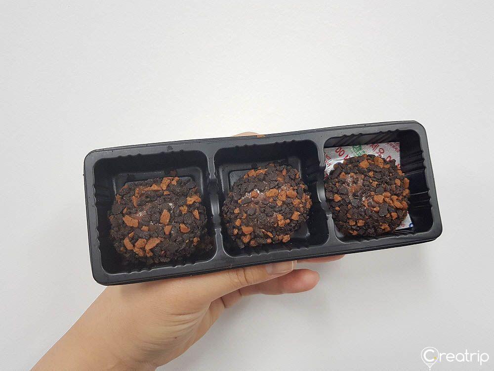 Three strawberry chocolate rice cake balls in a plastic tray from CU convenience store