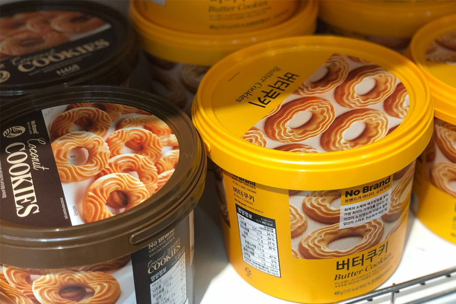 Containers of No Brand butter cookies with intricate designs. These cookies, available in flavors like chocolate and coconut, offer a delightful taste of rich buttery goodness, perfect for any sweet craving.