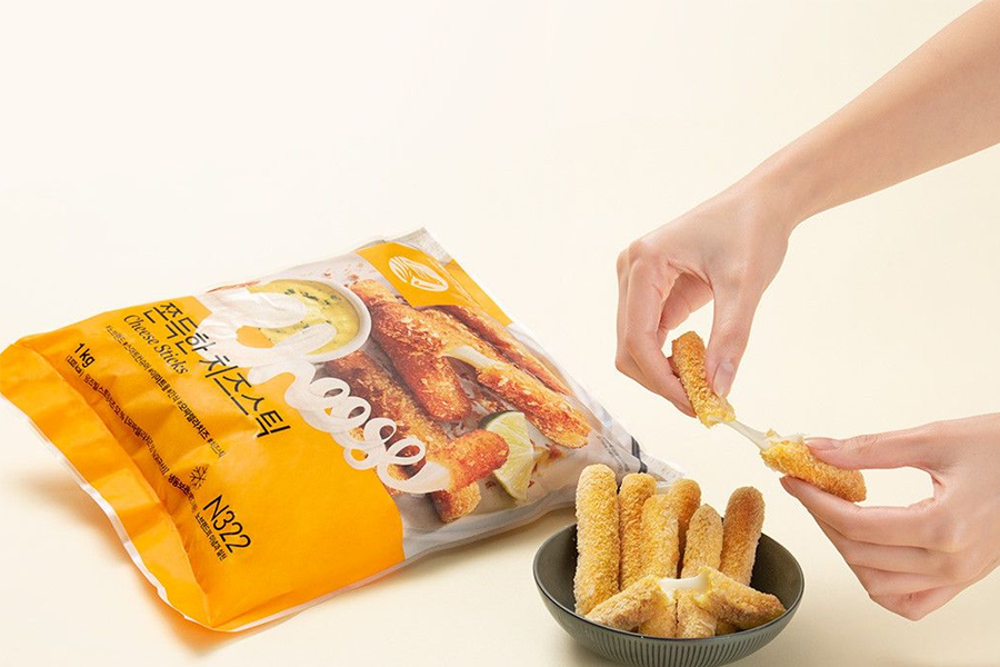Cheese sticks being prepared from a bag of No Brand cheese sticks. The image highlights the melted cheese inside, making it an enticing snack option for cheese enthusiasts.