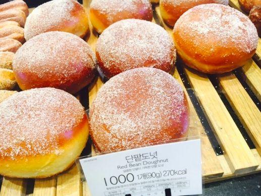 Close-up of Red Bean Doughnuts on Display - Showcasing the sugary coating and satisfying red bean flavor.