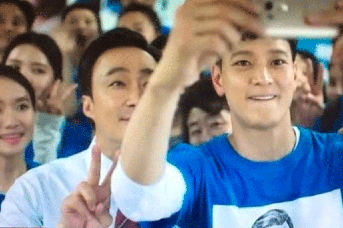 Group of people taking selfies and showing vibrant campaigning spirit, aiming to engage young voters in South Korea.