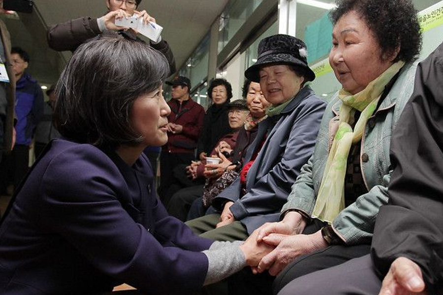 A group of elderly individuals in a community setting, reflecting the challenges of poverty among seniors in South Korea.
