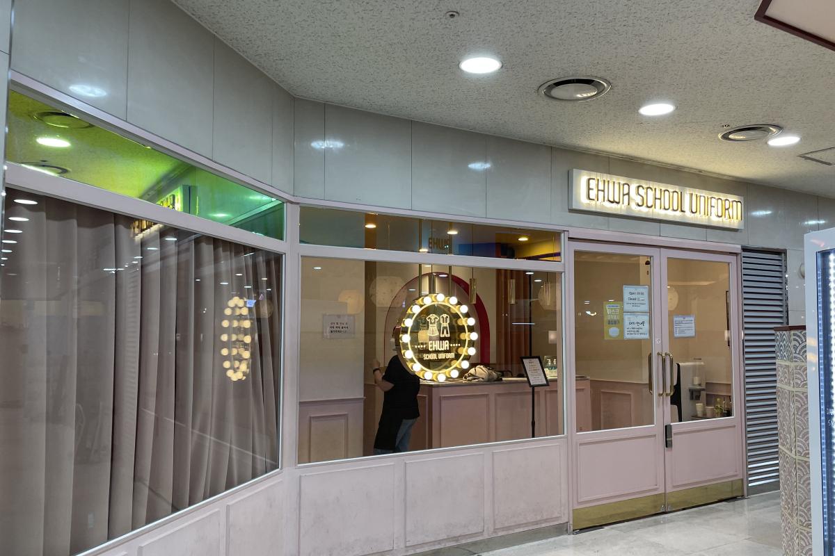 External view of the Ehwa School Uniform shop entrance, distinguished by its bright exterior facade and welcoming signage.