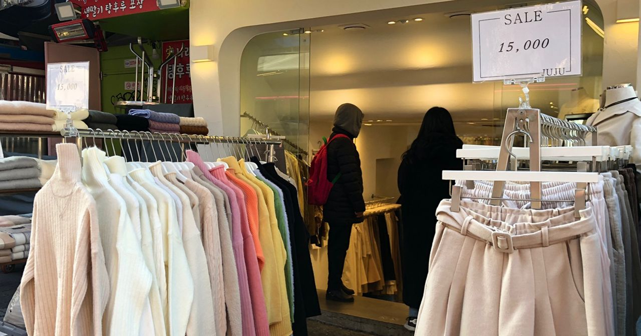 Display of sweaters on sale at a clothing shop in Hongdae, Seoul, capturing the local fashion scene.