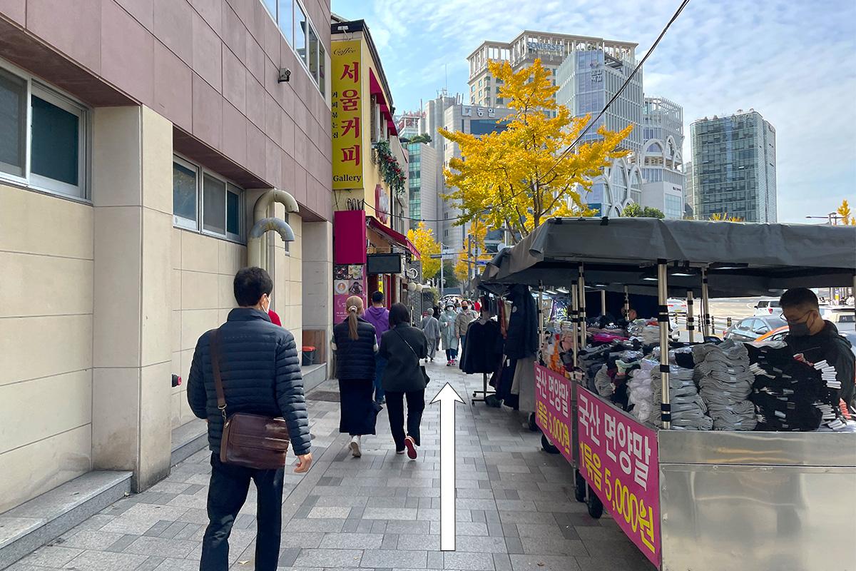 Street view from Anguk station towards Insadong, featuring shops and pedestrians.