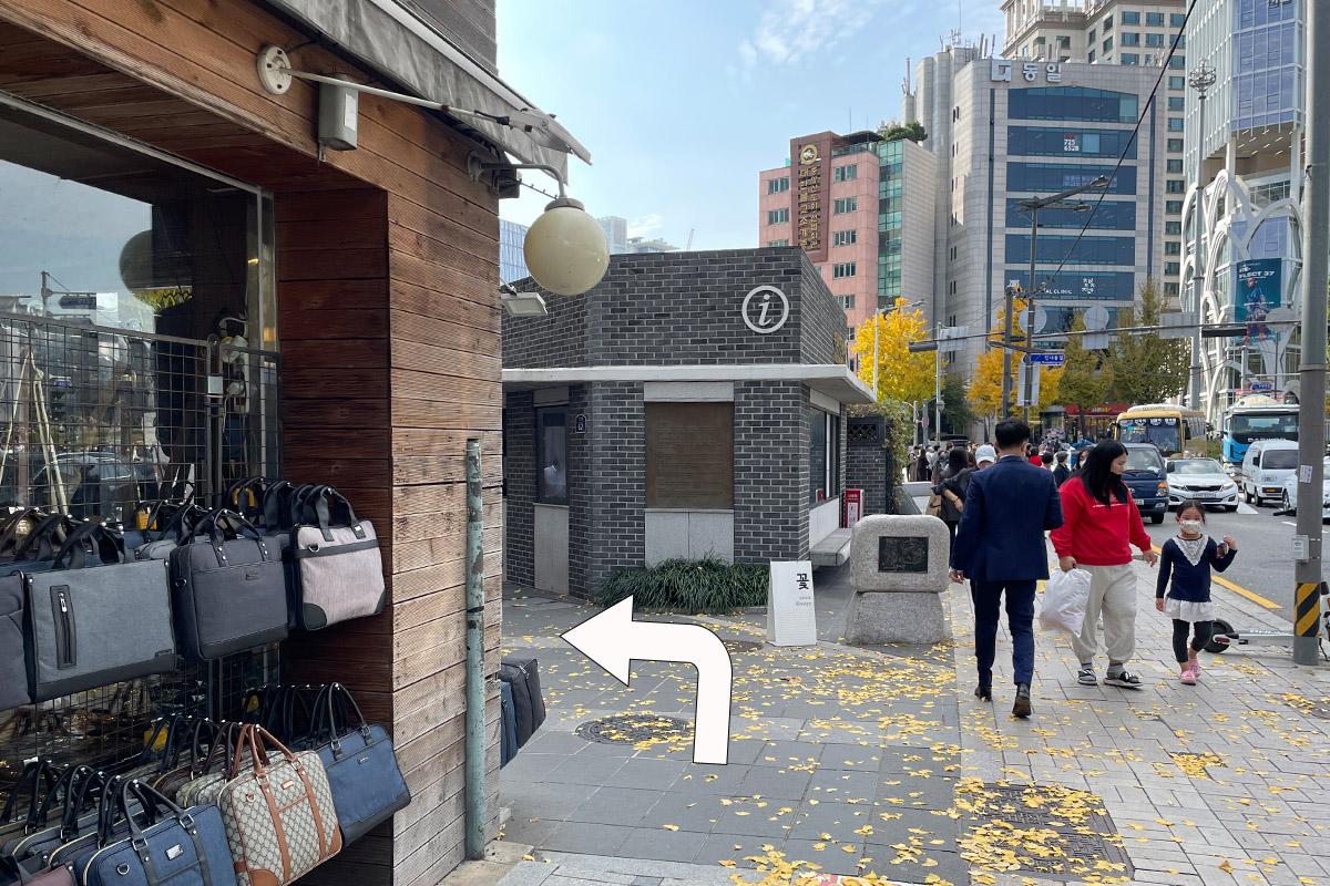 Turn left into Insadong street, Seoul with view of shops and trees.