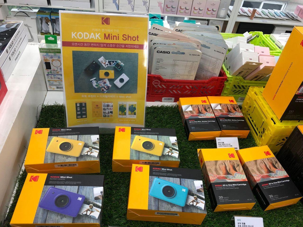 Kodak Mini Shot instant camera packaging options displayed in a store.