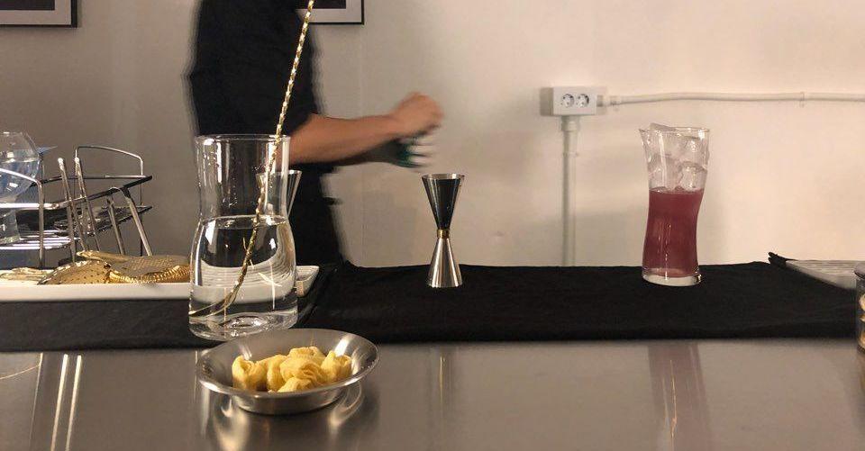 Bar setup with a focus on drinks and snacks being prepared.