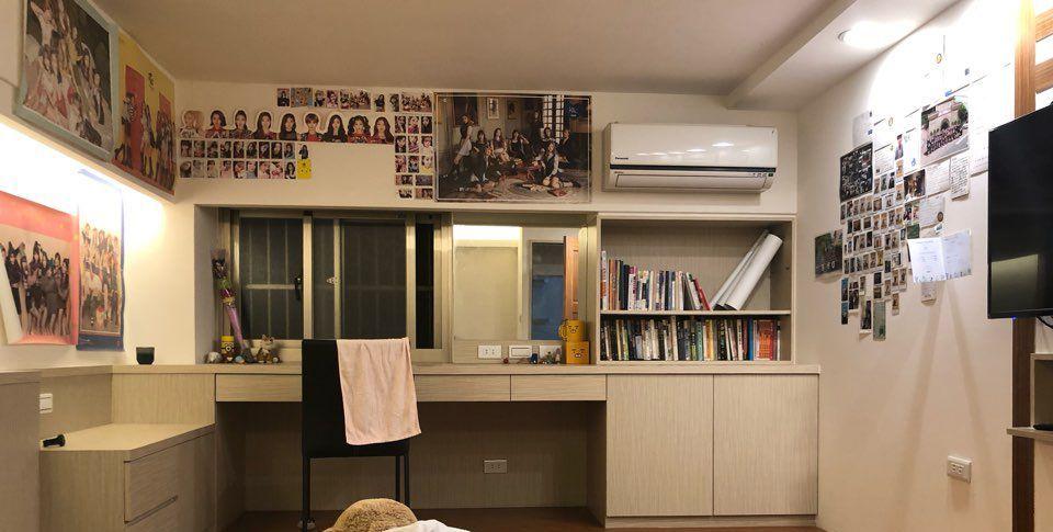 A desk with a uniquely personalized setup displaying a collection of photos and memories from travels.