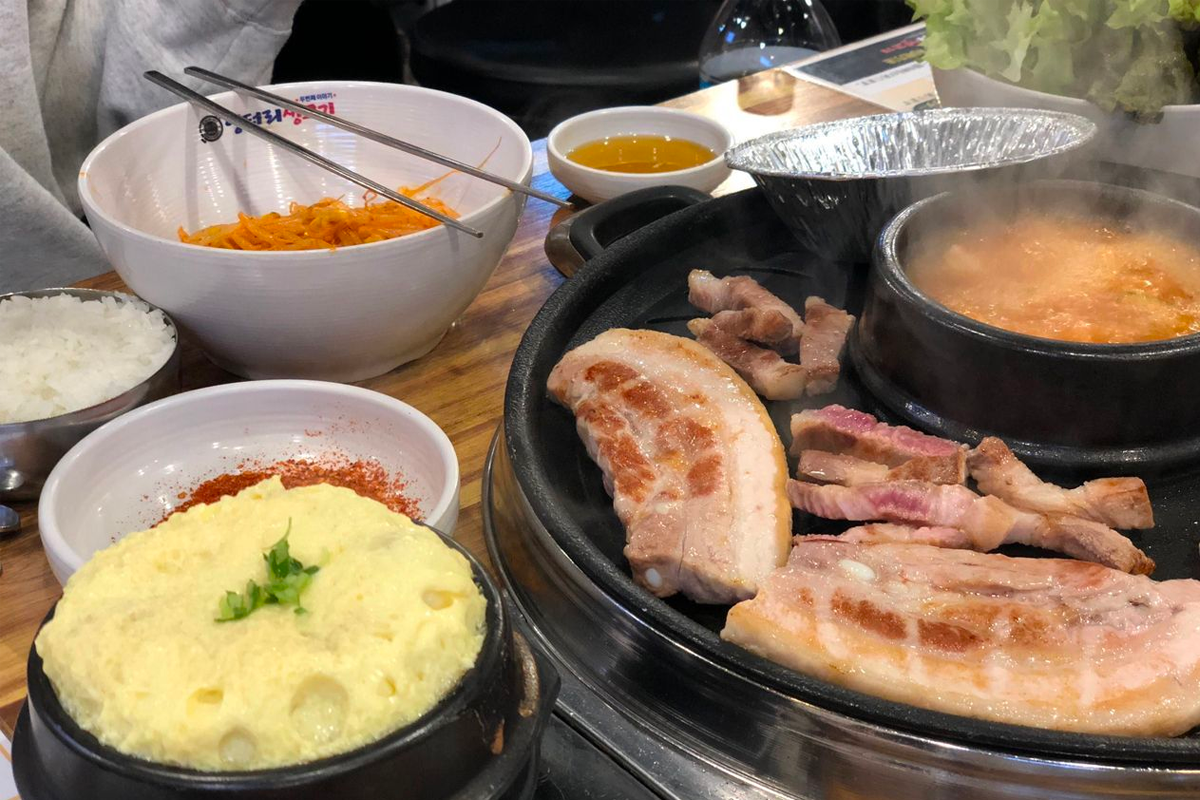Korean barbecue with various cuts of meat including Samgyeopsal, Galbi, and more.