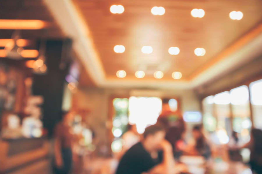 A cozy Korean restaurant interior with tables set for diners, offering a warm ambiance for guests.