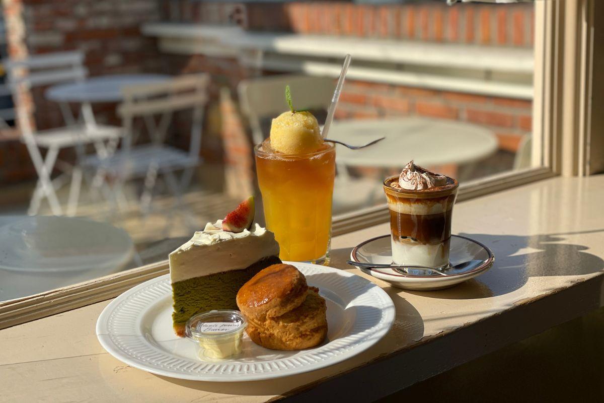 Delicious desserts at Cafe Layered in Yeonnam-dong including a green tea cake, scones, and refreshing drinks under natural light.
