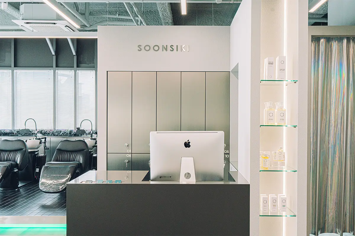 Vibrant decor and facilities at Soonsiki Hair Hongdae with promotional boards.