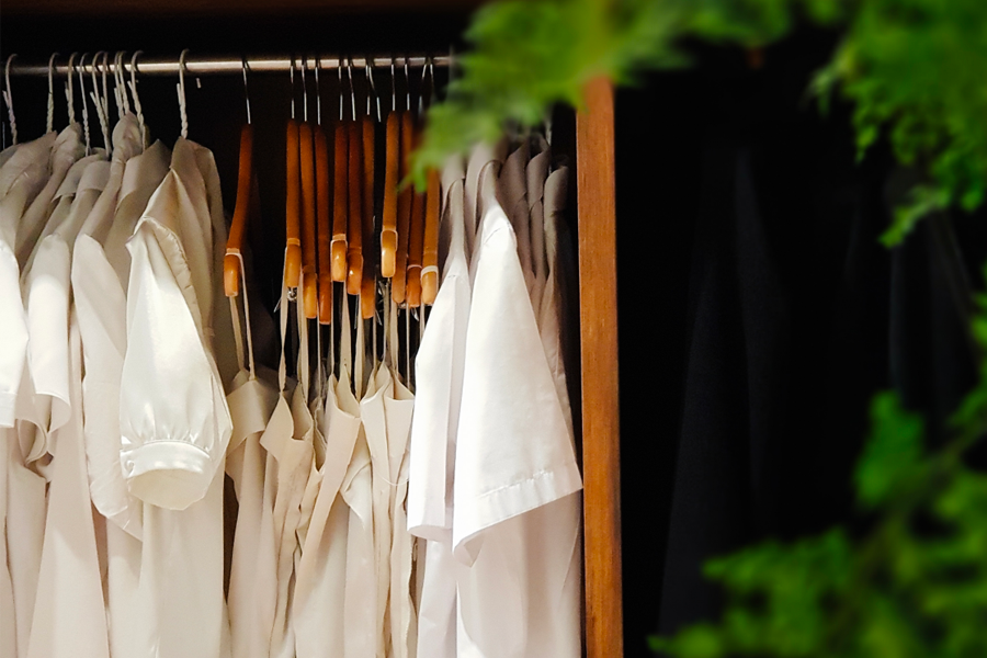 Wardrobe image showing neatly arranged formal and stylish clothing on hangers, available at Time On Me Studio.