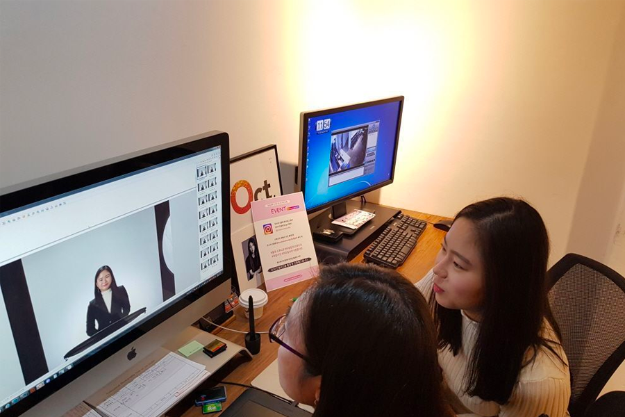 Time On Me Studio editing session showing two employees working at computers, where photo retouching is conducted.