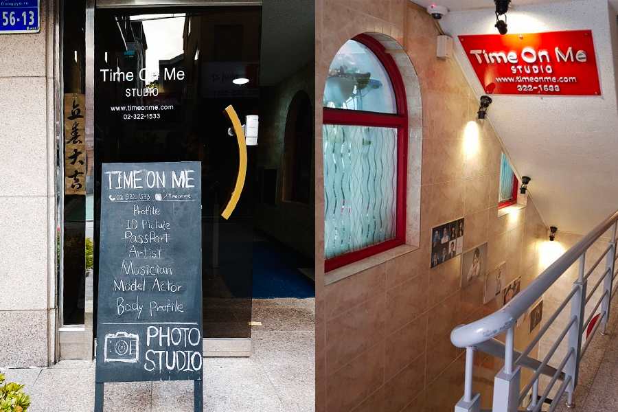Entrance of Time On Me Studio in Hongdae, featuring a signboard with promotional offers beside the entrance staircase.