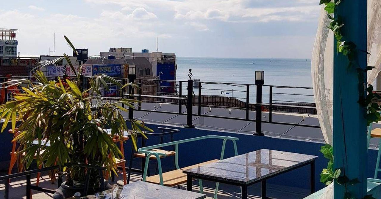 Rooftop coffee shop in Haeundae, Busan, offering stunning views of the city and the ocean.