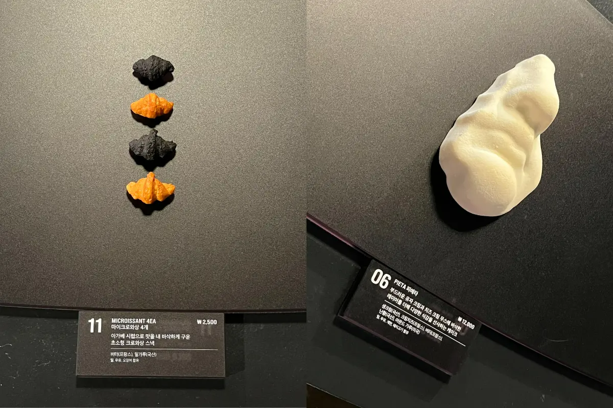 NUDAKE 聖水の黒いデザートと黄色のソースが印象的なスイーツのクローズアップ。