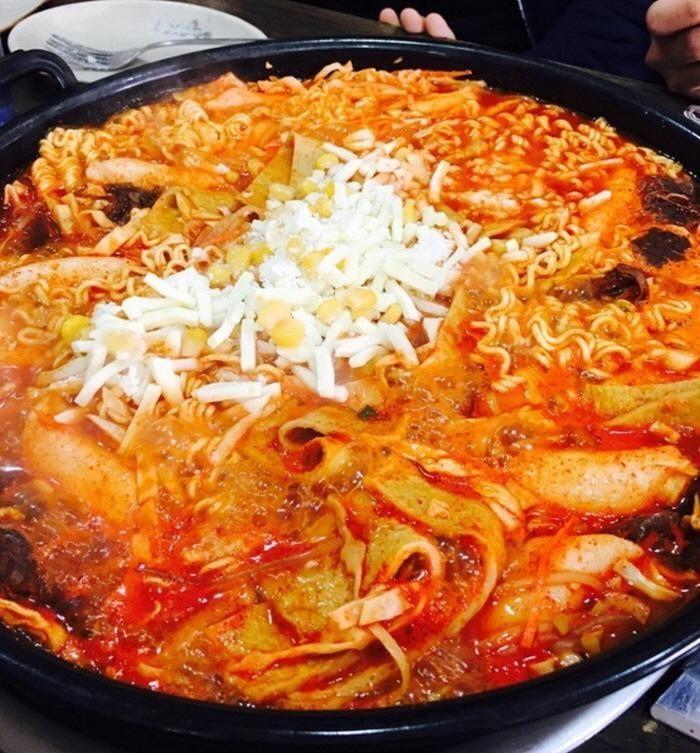 Serving freshly made tteokbokki from a street vendor.
