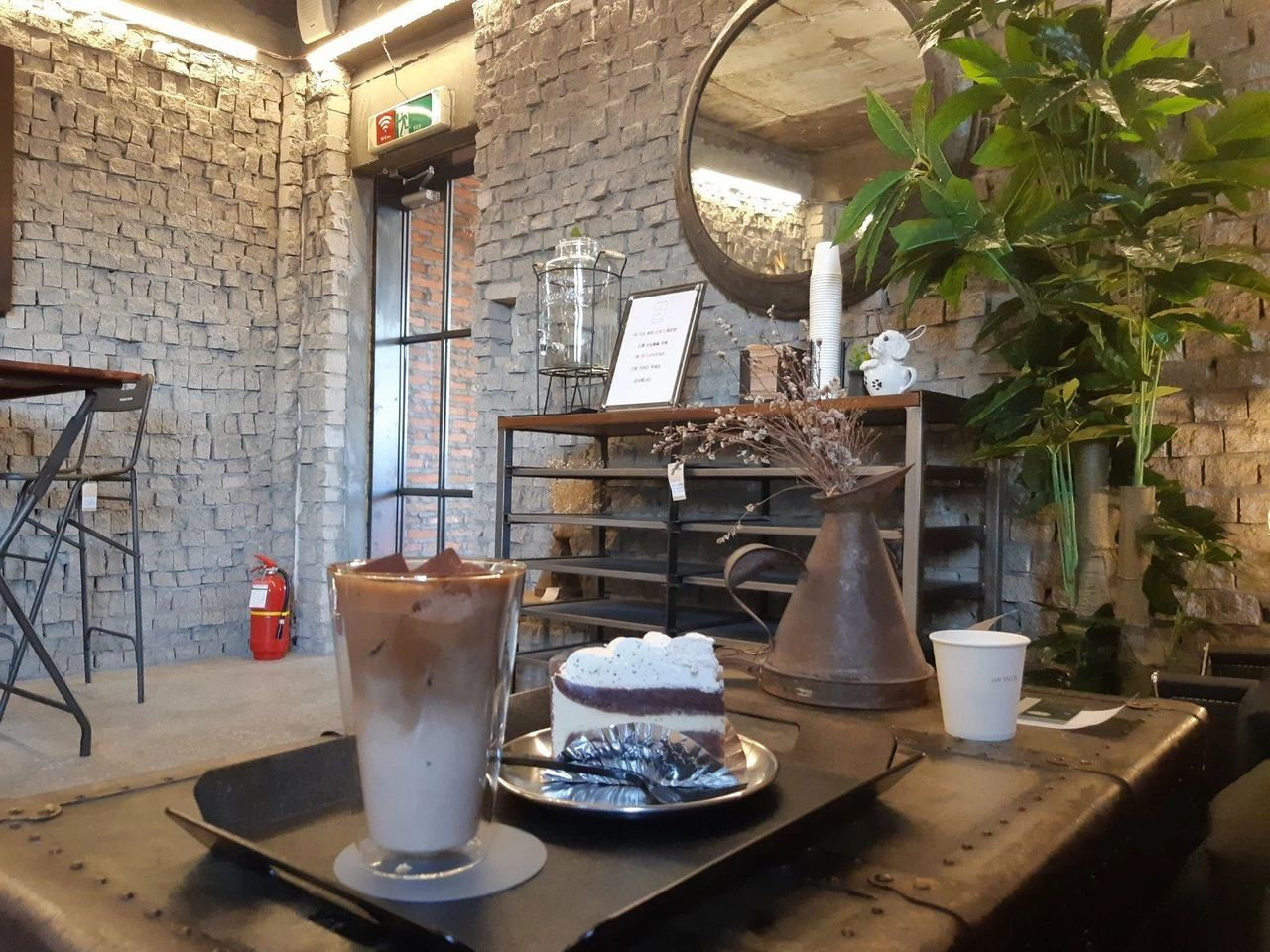 Decorative corner of Valor Cafe in Incheon, South Korea, emphasizing a retro and cinematic theme appealing to drama enthusiasts.