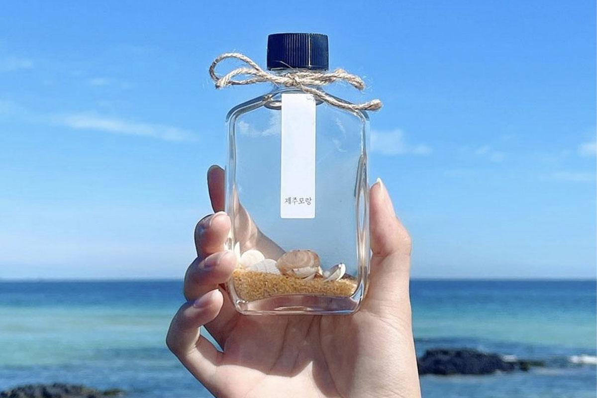 A Jeju Morang diffuser being held in front of the ocean.