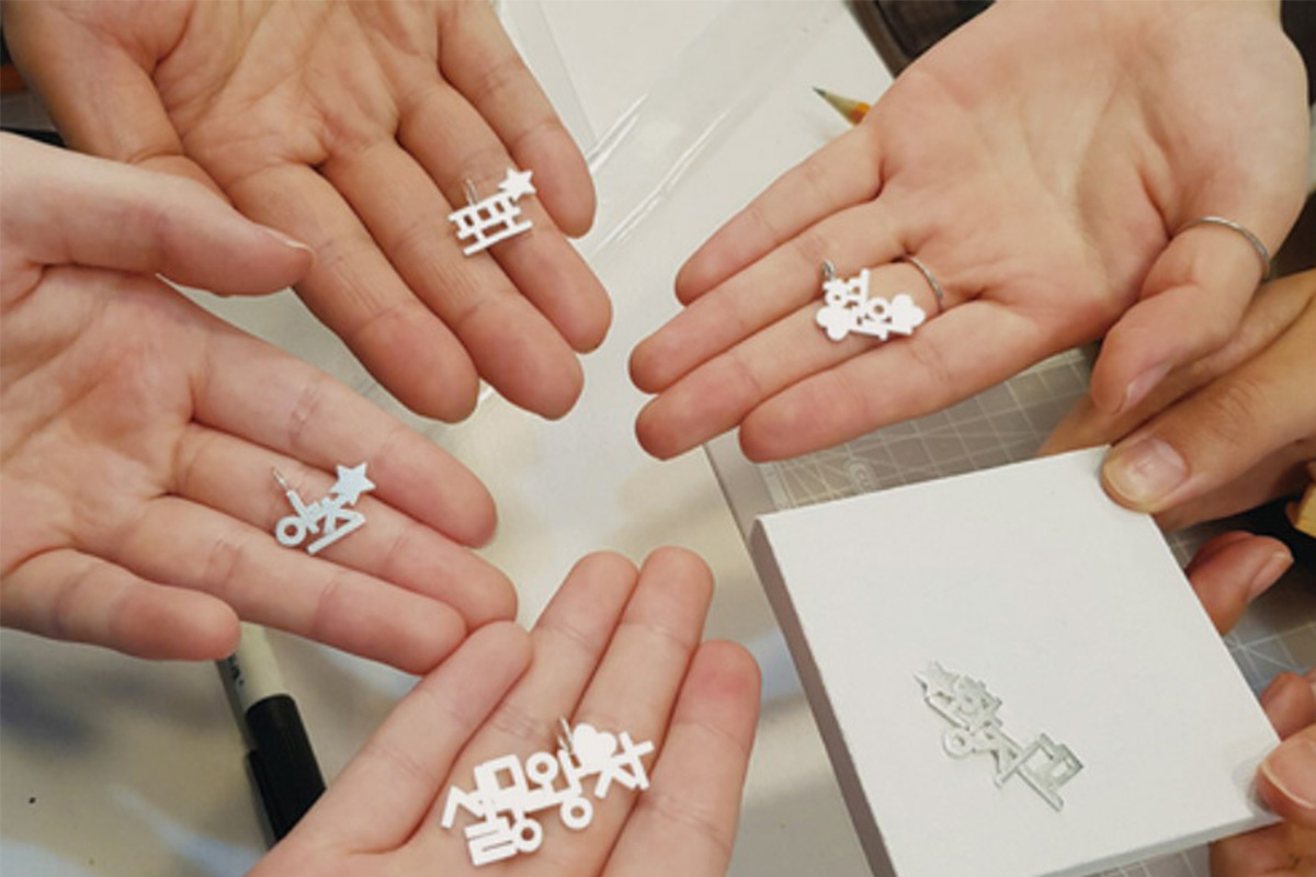 Handmade jewelry featuring Hangul, the Korean alphabet, crafted in a workshop in Seoul.
