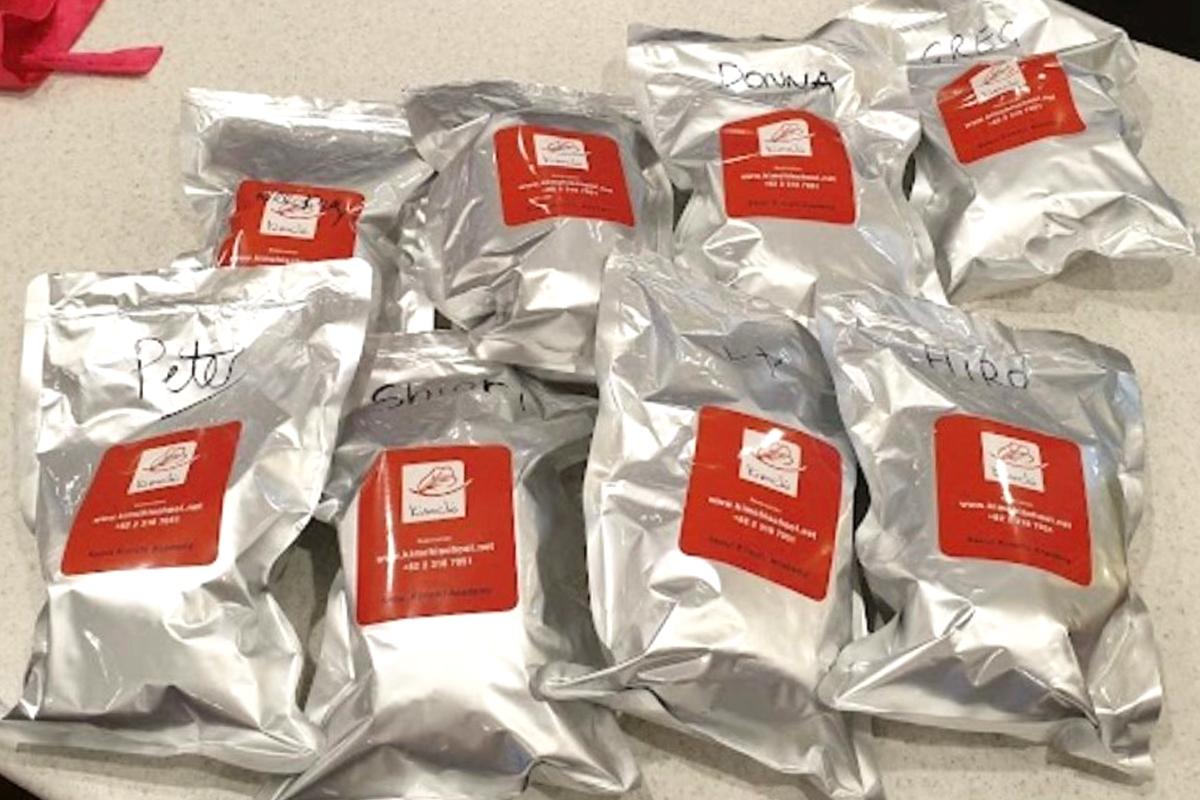 Close-up of a freshly cooked kimchi pancake served at a Korean cooking class.