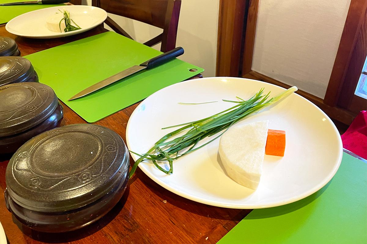 Cutting chives and preparing ingredients for kimchi making at Seoul Kimchi Academy.
