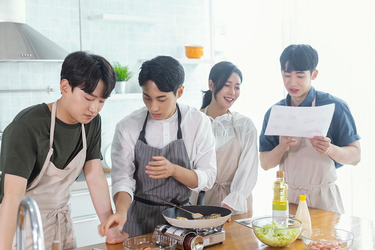 Kimchi making class in progress at the Seoul Kimchi Academy, showcasing the tools and setup.