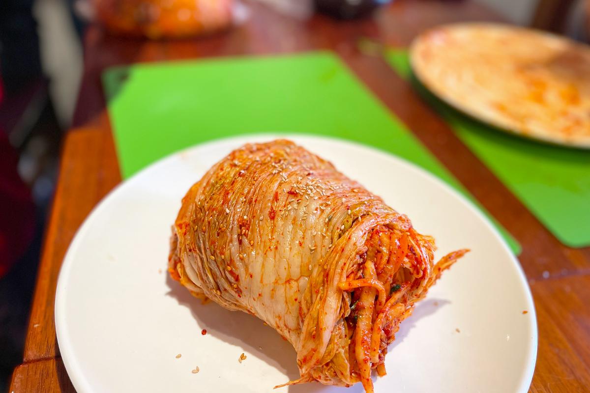 Class demonstration of making kimchi pancakes, a popular Korean dish.