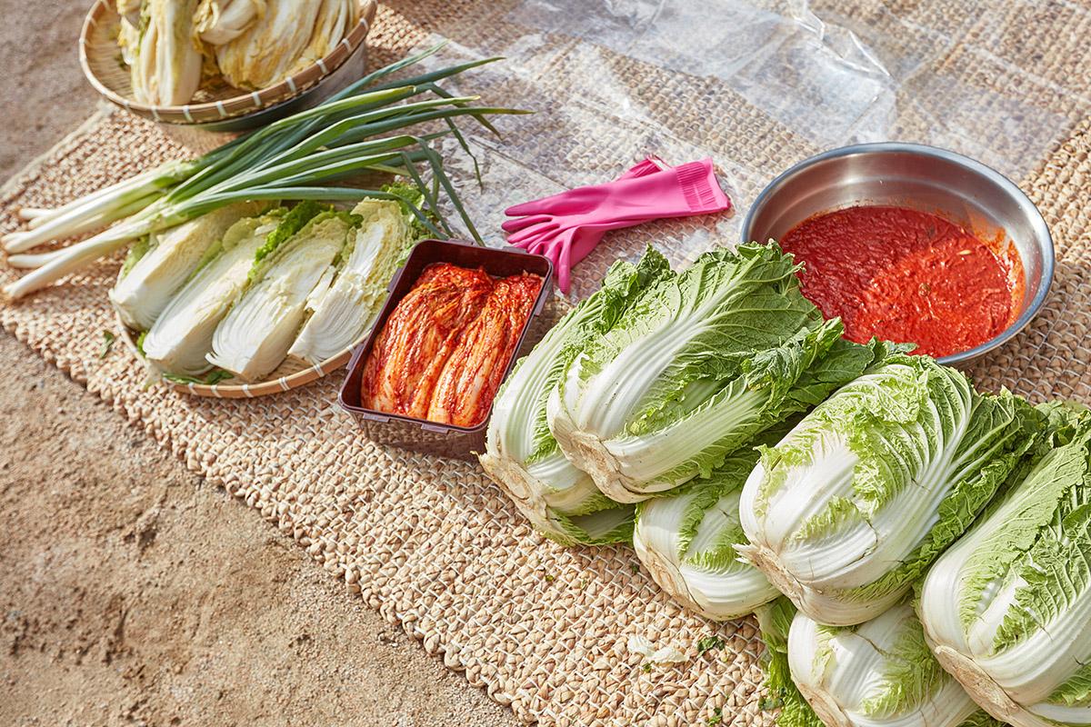 Preparation of kimchi ingredients including napa cabbage, kimchi paste, and green onions.