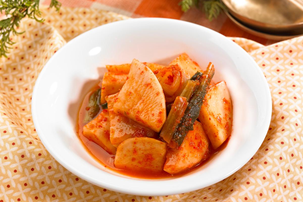 Class participation and preparation of kimchi ingredients during a session at Seoul Kimchi Academy.