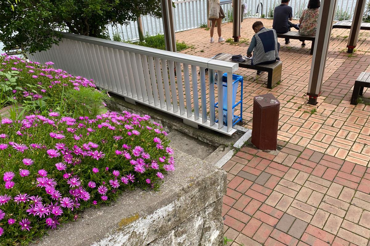 people sitting on benches in Huinnyeoul Culture Village